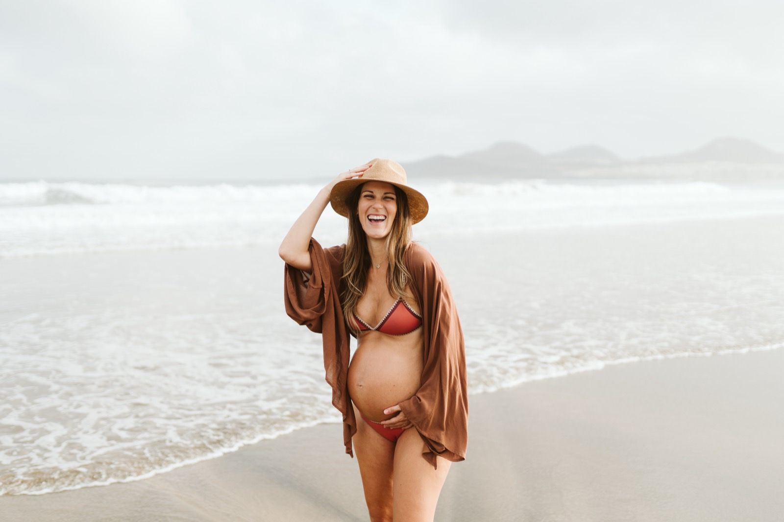 Mujer embarazada disfrutando de la brisa marina en la playa de Las Canteras, Gran Canaria